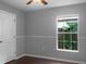 Simple bedroom with dark hardwood floors and a window at 11158 Golden Silence Dr, Riverview, FL 33579