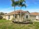 One-story house with tan exterior and palm trees at 11158 Golden Silence Dr, Riverview, FL 33579