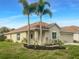 One-story house with tan exterior and palm trees at 11158 Golden Silence Dr, Riverview, FL 33579