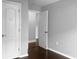 Bedroom with two doors and dark hardwood floors at 11158 Golden Silence Dr, Riverview, FL 33579