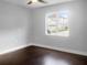 Spacious bedroom with dark hardwood floors and a large window at 11158 Golden Silence Dr, Riverview, FL 33579