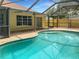 Relaxing kidney-shaped pool with a screened patio at 11158 Golden Silence Dr, Riverview, FL 33579
