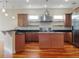 Spacious kitchen with island, stainless steel appliances, and hardwood floors at 1340 Apollo Beach S Blvd, Apollo Beach, FL 33572