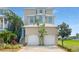 Three-story house with a two-car garage and landscaped front yard at 1340 Apollo Beach S Blvd, Apollo Beach, FL 33572