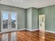 Green-walled bedroom with hardwood floors and access to en-suite bathroom at 1340 Apollo Beach S Blvd, Apollo Beach, FL 33572