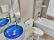 Bathroom with blue glass sink, white bathtub and tile flooring at 1340 Apollo Beach S Blvd, Apollo Beach, FL 33572