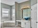Elegant bathroom with a large soaking tub, double vanity, and updated fixtures at 1340 Apollo Beach S Blvd, Apollo Beach, FL 33572