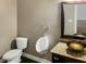 Bathroom with toilet, urinal, vessel sink, and granite countertop at 1340 Apollo Beach S Blvd, Apollo Beach, FL 33572