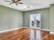 Bright bedroom with hardwood floors and French doors leading to a balcony at 1340 Apollo Beach S Blvd, Apollo Beach, FL 33572