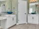 Bright bathroom with double sinks, marble countertops, and a walk-in shower at 1340 Apollo Beach S Blvd, Apollo Beach, FL 33572