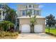 Three-story house with two-car garage and lush landscaping at 1340 Apollo Beach S Blvd, Apollo Beach, FL 33572