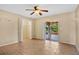 Bedroom with sliding doors to patio and ceiling fan at 18509 Bittern Ave, Lutz, FL 33558