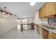 Open kitchen with breakfast bar and view to living area at 6400 46Th N Ave # 102, Kenneth City, FL 33709