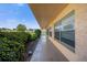Ground-level walkway of a condo building with lush landscaping and exterior view at 6400 46Th N Ave # 102, Kenneth City, FL 33709