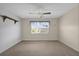 Simple bedroom with ceiling fan and a window providing natural light at 6400 46Th N Ave # 102, Kenneth City, FL 33709