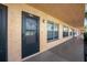 Exterior view of condo unit's entrance and walkway with surrounding vegetation at 6400 46Th N Ave # 102, Kenneth City, FL 33709