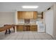 Efficient kitchen with white appliances and wood cabinets at 6400 46Th N Ave # 102, Kenneth City, FL 33709