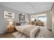 Bright bedroom with a large bed, built-in shelves, and an ensuite office area at 6400 46Th N Ave # 102, Kenneth City, FL 33709