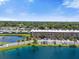 Aerial view of an apartment building beside a tranquil lake at 6400 46Th N Ave # 102, Kenneth City, FL 33709