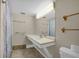 Clean bathroom with a shower/tub combo, vanity, and tiled floors at 6400 46Th N Ave # 102, Kenneth City, FL 33709