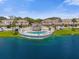 Community pool with surrounding deck and lake view at 6400 46Th N Ave # 102, Kenneth City, FL 33709