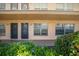 Exterior view of a condo building showcasing two ground floor units at 6400 46Th N Ave # 102, Kenneth City, FL 33709