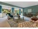 Spacious living area with large windows and comfortable seating at 5462 Chanteclaire # 65, Sarasota, FL 34235