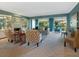 Light-filled living room with fireplace and views of the backyard at 5462 Chanteclaire # 65, Sarasota, FL 34235