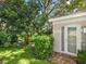 Landscaped backyard with lush greenery and access to a private, exterior room at 5462 Chanteclaire # 65, Sarasota, FL 34235