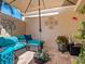 Relaxing covered patio with comfortable seating and umbrella at 5462 Chanteclaire # 65, Sarasota, FL 34235