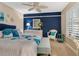 Serene bedroom boasts a king-size bed, accent chair, and a beautiful blue accent wall at 5462 Chanteclaire # 65, Sarasota, FL 34235