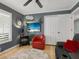 Relaxing den featuring a red accent chair, electric fireplace, and built-in shelving at 5462 Chanteclaire # 65, Sarasota, FL 34235