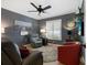 Cozy home office features a ceiling fan, comfortable seating, and large window with plantation shutters at 5462 Chanteclaire # 65, Sarasota, FL 34235