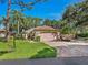 Single-story home with two-car garage and lush green lawn at 5462 Chanteclaire # 65, Sarasota, FL 34235