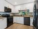Modern kitchen featuring granite countertops, stainless steel appliances, and white shaker cabinets at 5462 Chanteclaire # 65, Sarasota, FL 34235