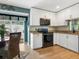 Updated kitchen with granite countertops, stainless steel appliances, and white cabinets at 5462 Chanteclaire # 65, Sarasota, FL 34235