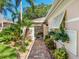 Welcoming entryway with lush landscaping and brick walkway at 5462 Chanteclaire # 65, Sarasota, FL 34235