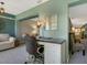 Bright home office features a desk, comfortable chair, and view into adjacent living space at 5462 Chanteclaire # 65, Sarasota, FL 34235