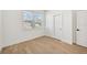 Bright bedroom with light wood flooring and a sliding door closet at 108 Runaway Field Ave, Nokomis, FL 34275