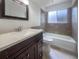 Updated bathroom with dark vanity and tiled shower/tub at 1052 Longfellow Cir, Sarasota, FL 34243