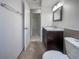 Clean bathroom with dark brown vanity and tile flooring at 1052 Longfellow Cir, Sarasota, FL 34243