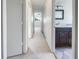 Bright hallway with light carpet and access to bedrooms and bathrooms at 1052 Longfellow Cir, Sarasota, FL 34243