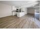 Open living area with wood-look tile floors and access to patio at 1052 Longfellow Cir, Sarasota, FL 34243