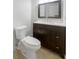 Updated bathroom with dark brown vanity and marble countertop at 1052 Longfellow Cir, Sarasota, FL 34243