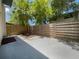 Small, private backyard with wooden fence and palm tree at 1052 Longfellow Cir, Sarasota, FL 34243