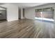 Open living area with wood-look tile flooring and sliding door to patio at 1052 Longfellow Cir, Sarasota, FL 34243