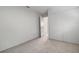 Well lit bedroom with carpet floors and an open door to another room at 1052 Longfellow Cir, Sarasota, FL 34243