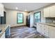Modern kitchen with white cabinets, granite counters, and stainless steel appliances at 210 15Th E St, Bradenton, FL 34208