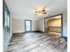 Large bedroom with wood-look floors, ceiling fan, and access to upper hallway at 210 15Th E St, Bradenton, FL 34208
