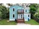 Rear view of two story light blue house with deck at 210 15Th E St, Bradenton, FL 34208